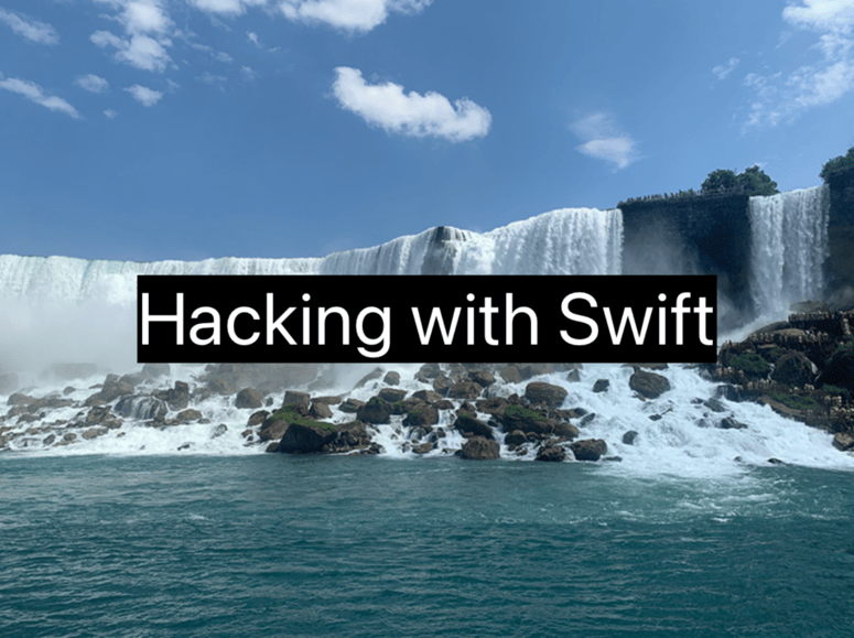“Hacking with Swift” in white text on a black rectangle, centered over an image of Niagara Falls.
