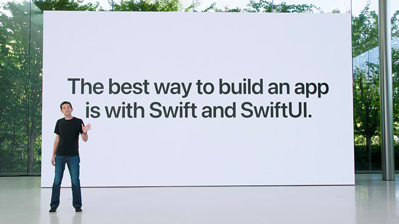 Josh Schaffer standing in front of a sign reading: The best way to build an app is with Swift and SwiftUI.